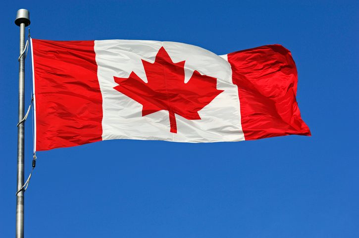 Canadian flag on blue sky